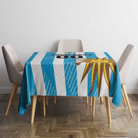 Blue custom tablecloth with sunburst and football graphics on a square table, top view