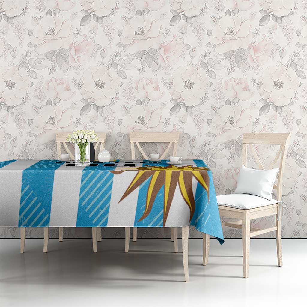 Blue Uruguay-themed football tablecloth with sunburst design on a dining table