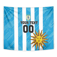 Blue wall tapestry featuring white stripes, crest emblem, sun icon, and “YOUR TEXT 00”