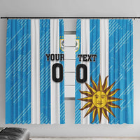 Blue window curtain with Uruguay flag emblem and sun motif print, hanging-ready