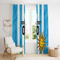 Blue window curtain with white vertical stripes and a large sun emblem