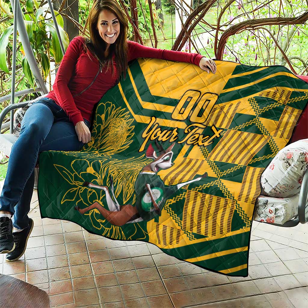 Custom South Africa rugby quilt laid on patio seating, yellow-and-green with floral and animal