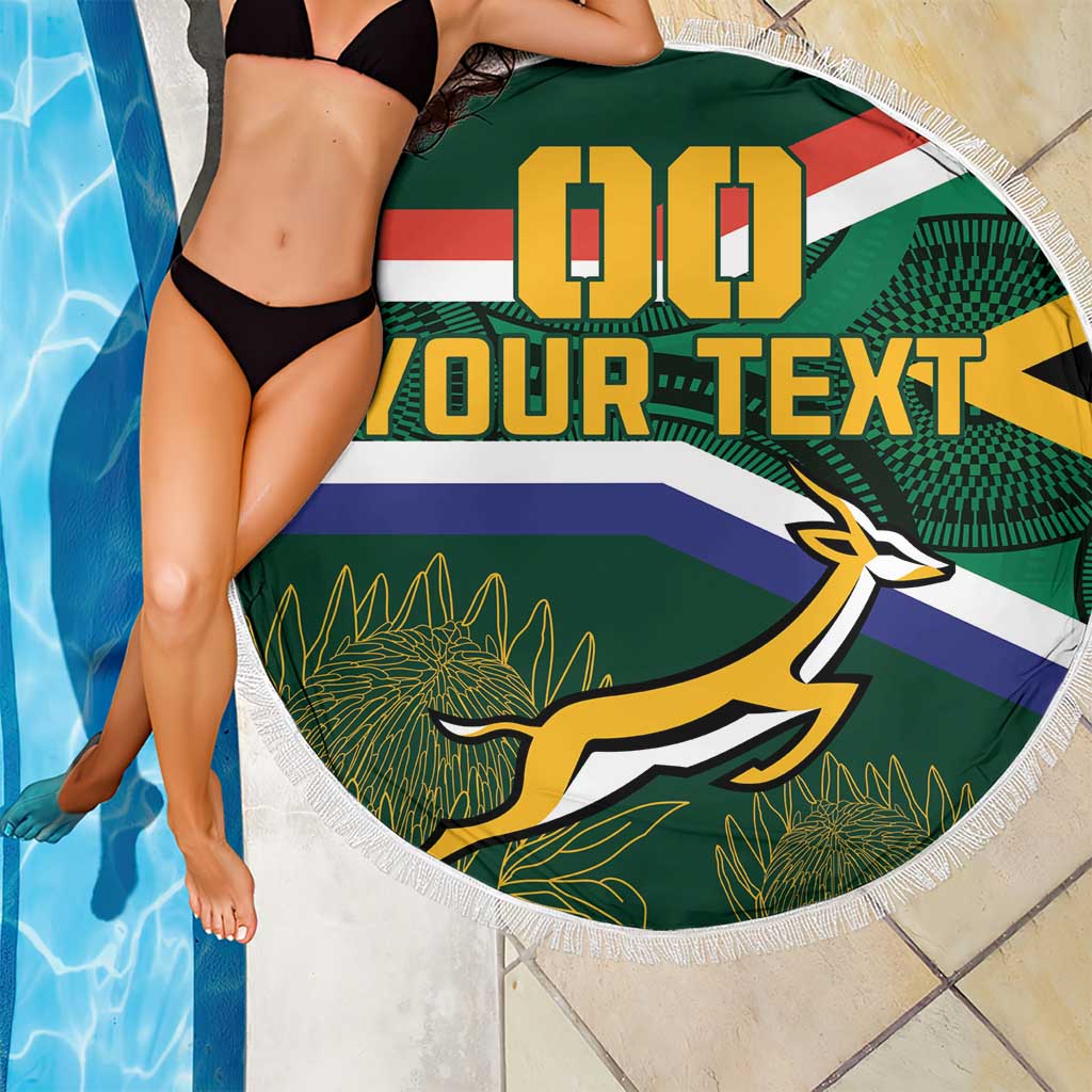 Round South Africa rugby beach blanket with Springbok mascot and fringe, poolside view