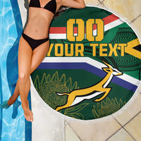 Round South Africa rugby beach blanket with Springbok mascot and fringe, poolside view