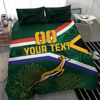 Green rugby bedding set with flag stripes and springbok graphic, shown on a bed