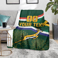 Green blanket on gray couch, flag stripes with 00 and YOUR TEXT, springbok graphic