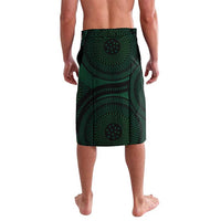 Green patterned shorts with repeating circular motif and elastic waistband