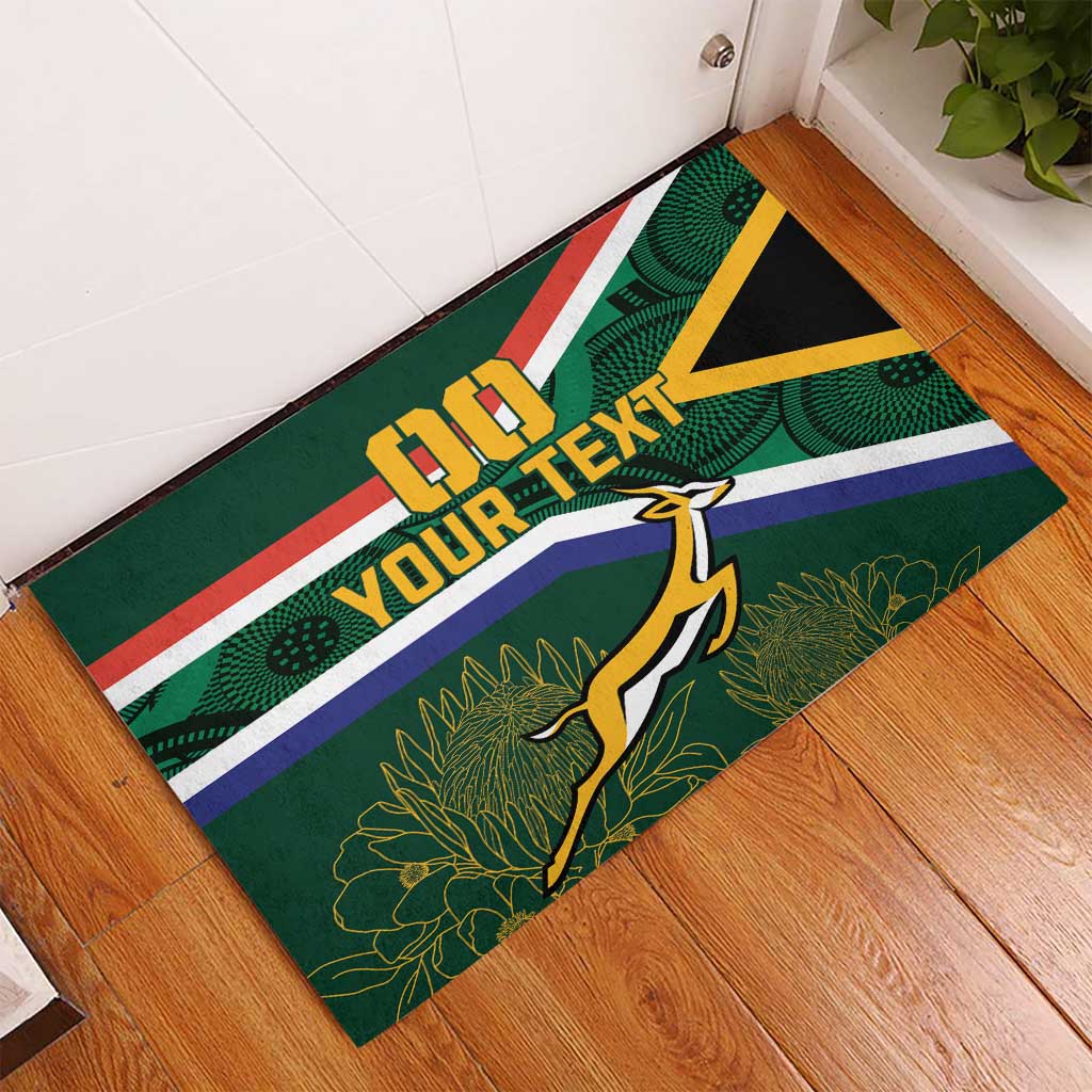 Green rubber doormat with South Africa stripes, yellow accent, and 'YOUR TEXT' lettering.