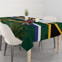 Rugby tablecloth draped over table with green, blue, and gold stripes and leaf motif