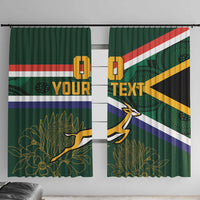 Close view of green curtain panels with South Africa flag stripes and springbok graphic.