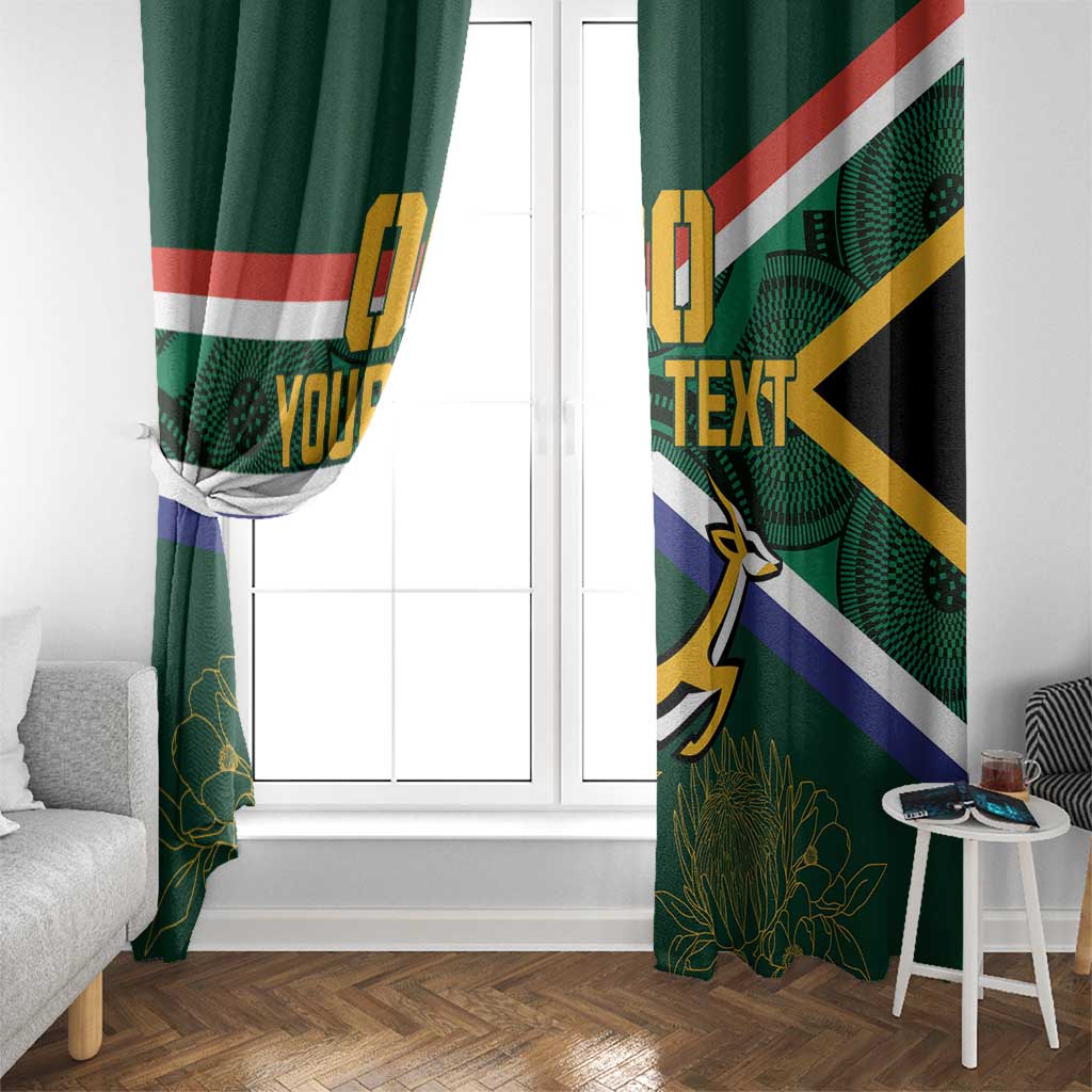 Pair of green window curtains with South Africa flag stripes and springbok motif.