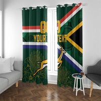 Green window curtains with South Africa flag stripes, springbok motif, and floral vines.