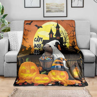 Orange Halloween blanket draped over couch with haunted house and pumpkin character art
