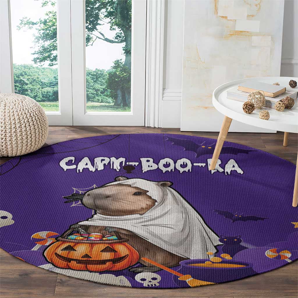Purple Halloween round carpet with capybara in gray cape, pumpkin and bats pattern