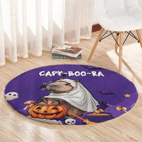 Purple round Halloween rug with capybara, jack-o'-lantern, bats and ghost motifs