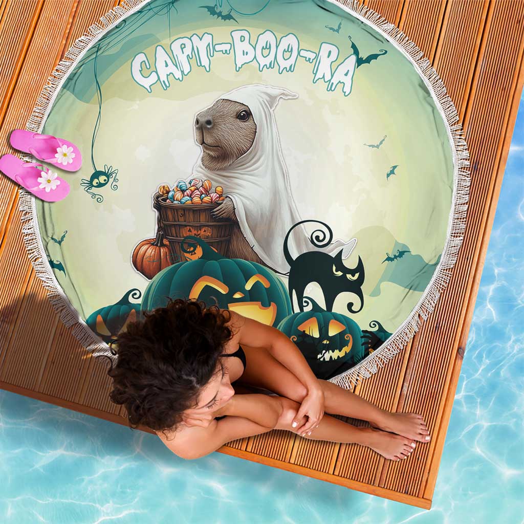Round green Halloween beach blanket featuring capybara, pumpkins, and spooky cat graphics