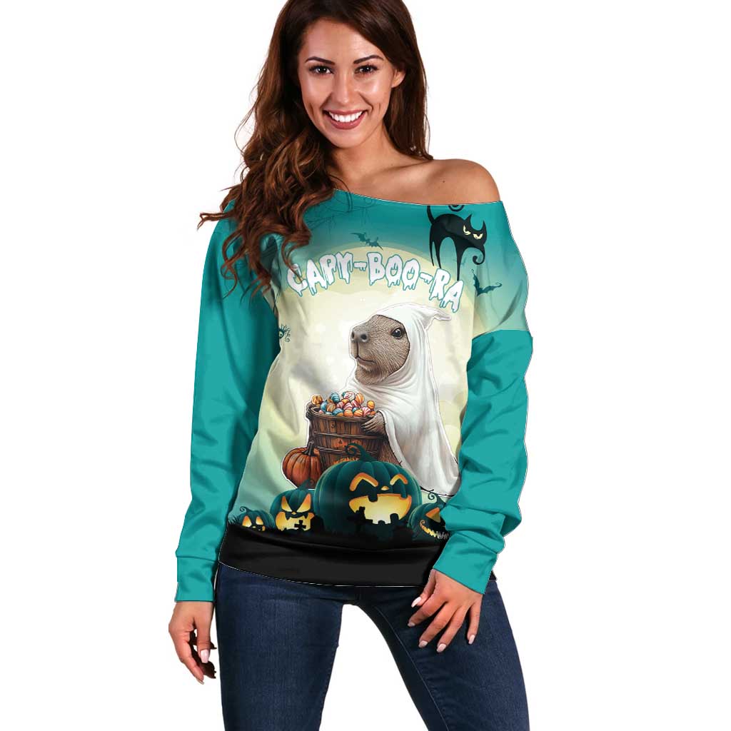 Women’s green off-shoulder sweater with cartoon critter, pumpkins, and spooky graphics