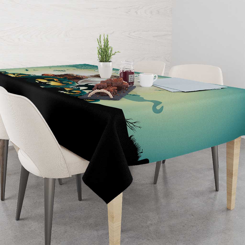 Green Halloween tablecloth with spooky field scene across the table