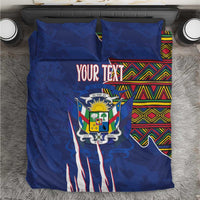 Blue duvet cover set with coat of arms, colorful kente stripe panels, and two matching pillows