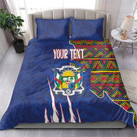 Blue bedding set with “YOUR TEXT” crest center and kente stripe side panels plus two pillows