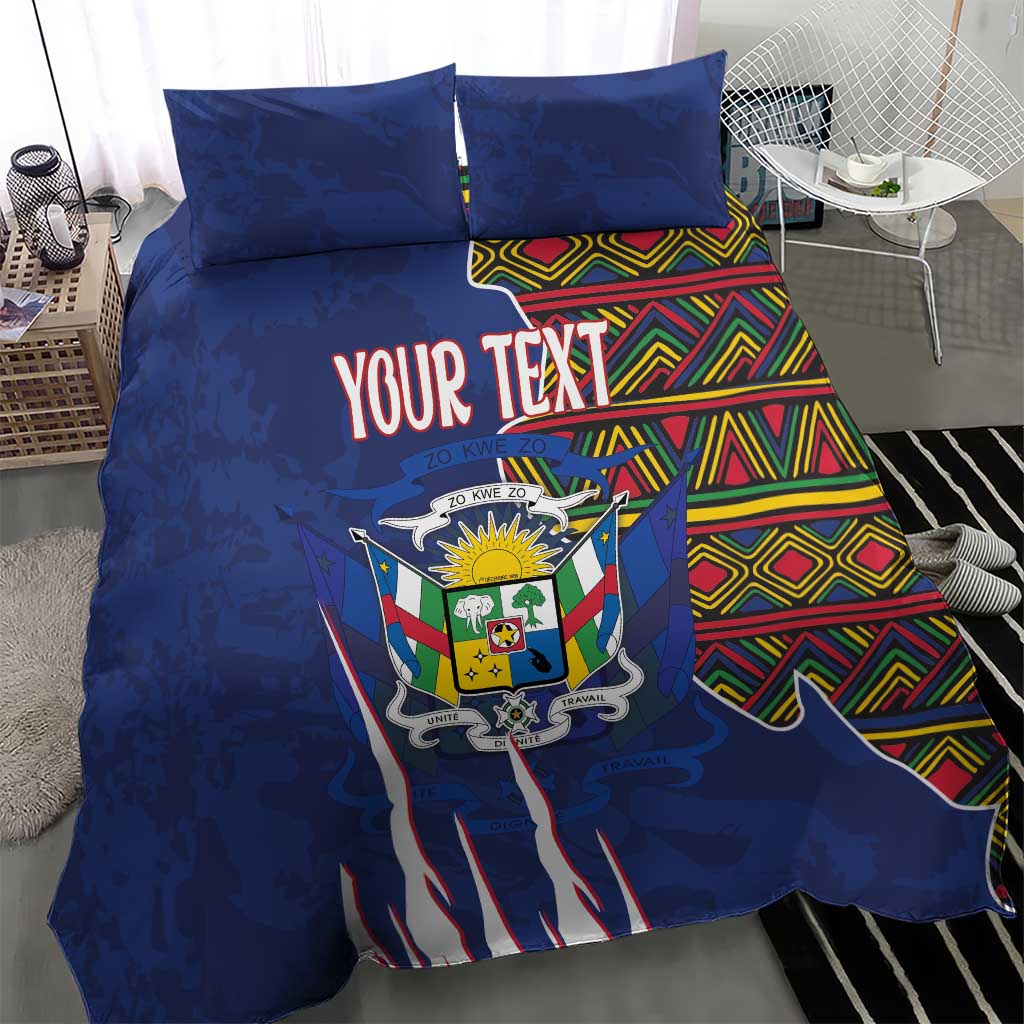 Blue duvet cover with “YOUR TEXT” coat of arms and kente stripe accents, shown on a bed