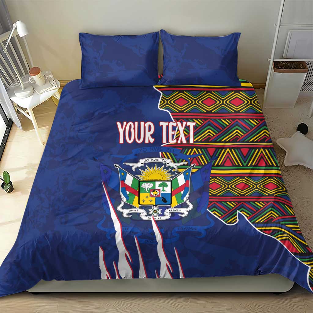 Blue duvet cover set with coat of arms graphic, colorful kente stripe panel, and two pillows