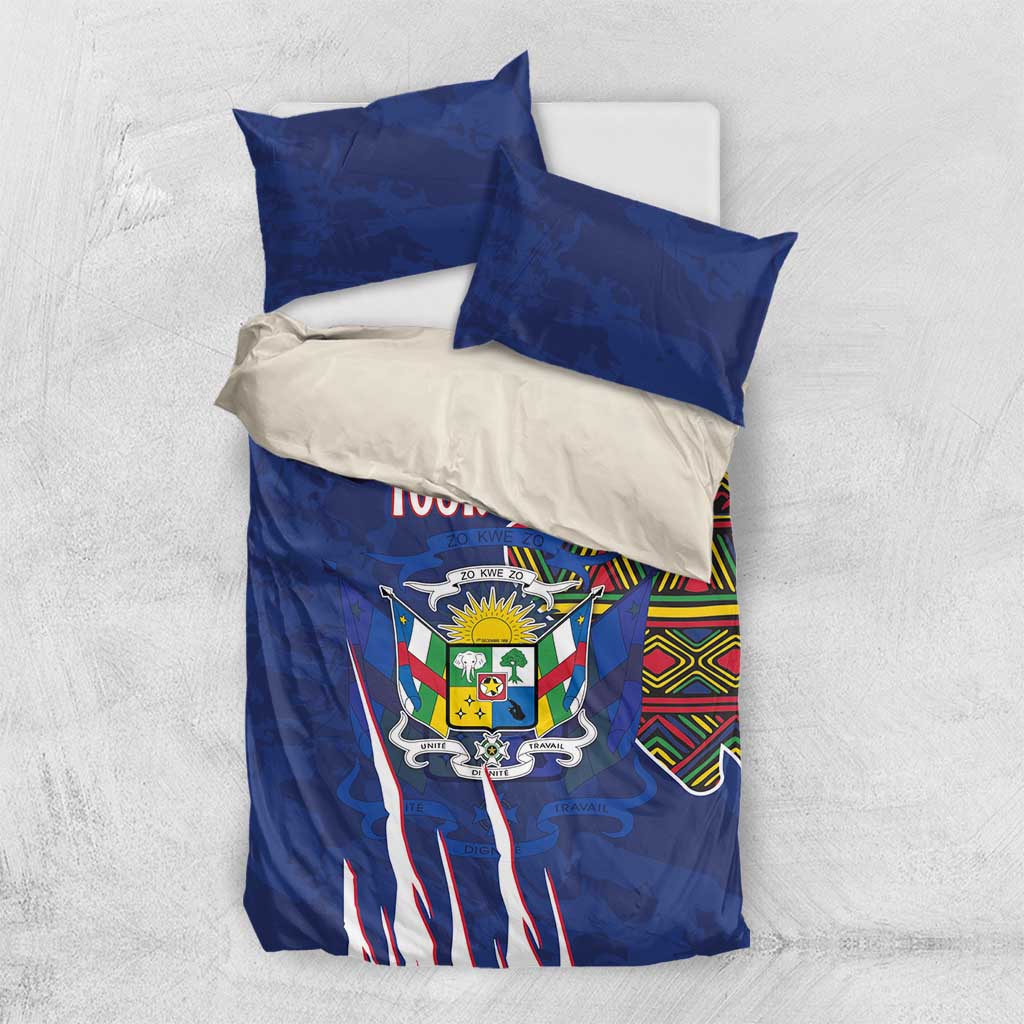 Blue and white bedding set with coat of arms graphic, kente stripe corner, and two pillows