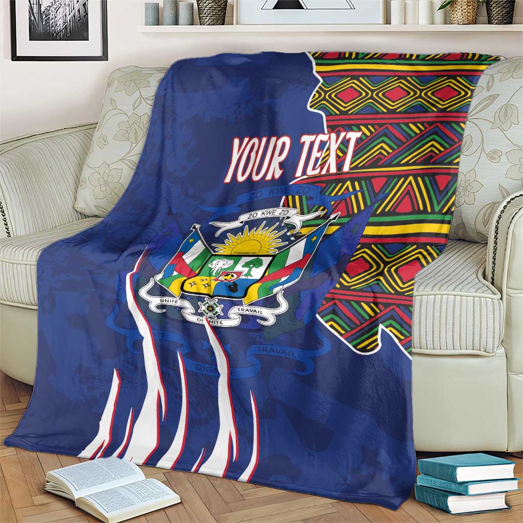 Personalized blue blanket on an armchair with coat of arms emblem, kente header, and text