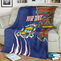 Personalized blue blanket on an armchair with coat of arms emblem, kente header, and text