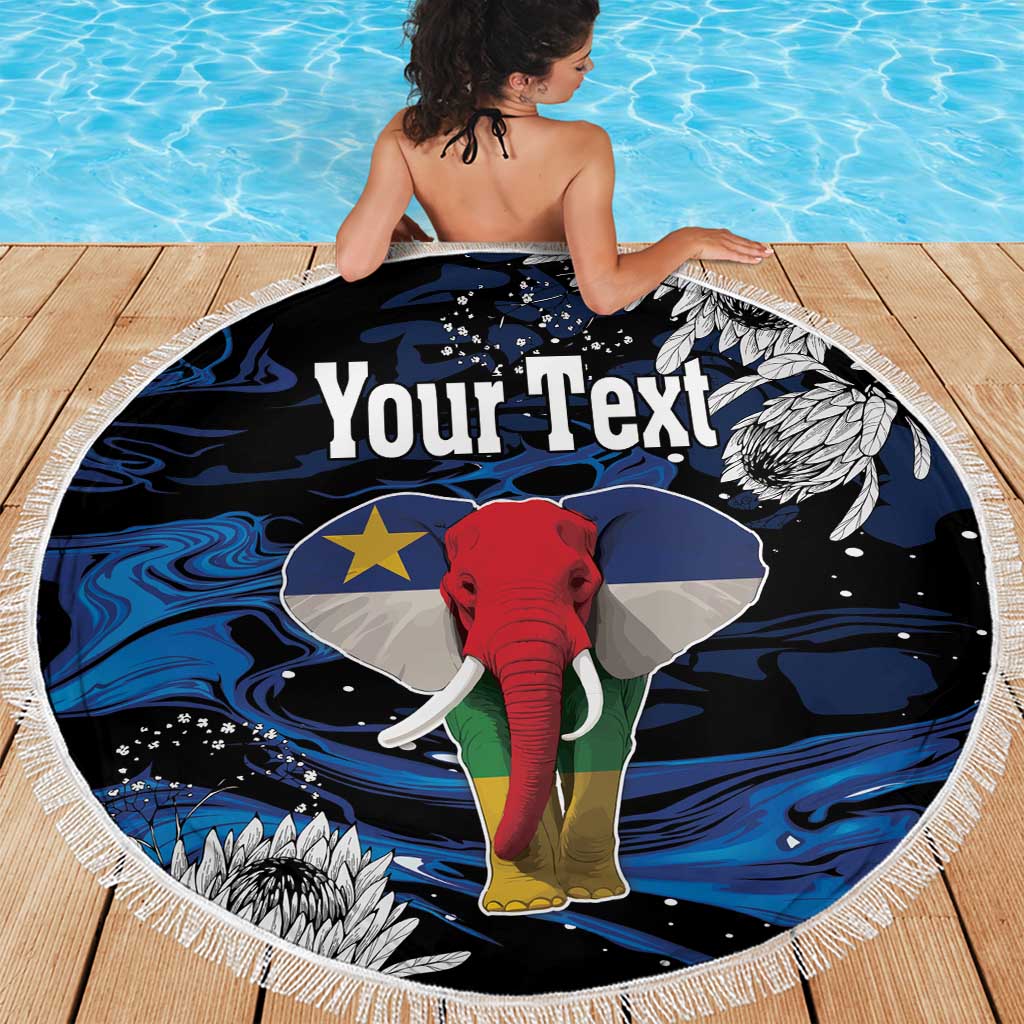 Round beach blanket with fringe, black blue elephant graphic with 'Your Text' on wooden deck