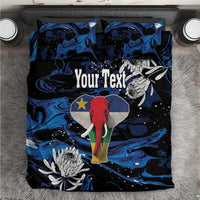 King bedding set with blue-black elephant print, protea flowers, and matching pillowcases