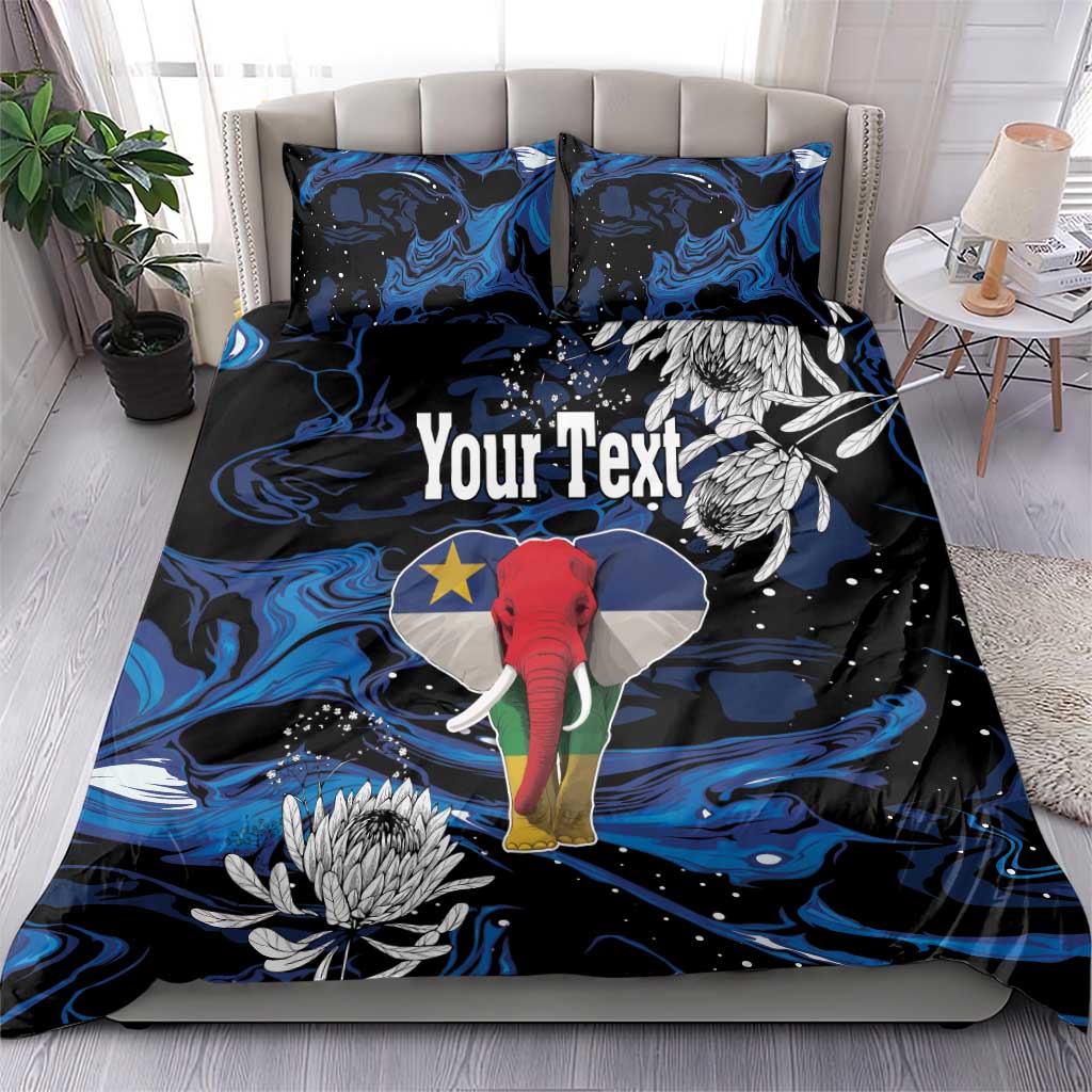 King bedding set on bed: blue-black elephant artwork with protea flowers on duvet and pillows