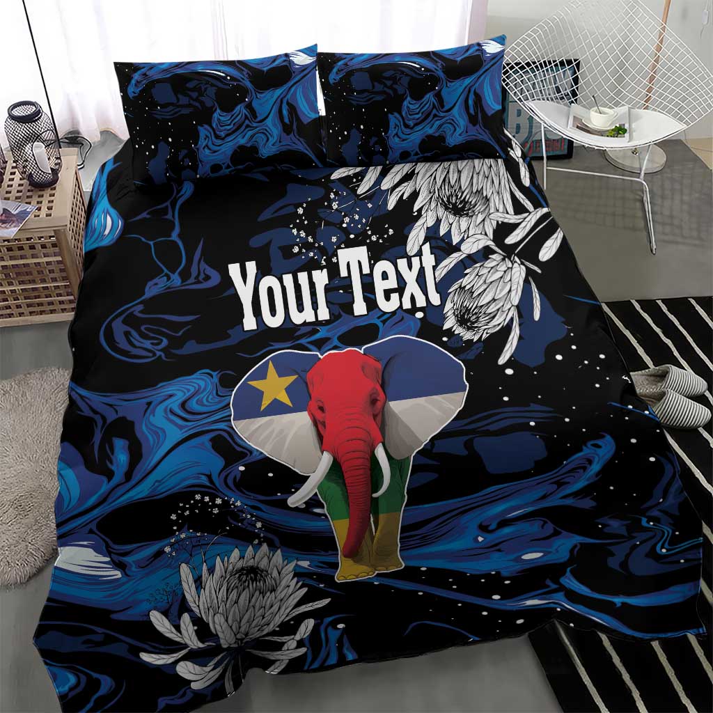 Blue-black elephant duvet set with protea blooms and custom text on duvet; two matching pillows