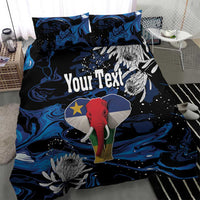 Blue-black elephant duvet set with protea blooms and custom text on duvet; two matching pillows
