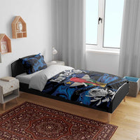 King bedding set on wooden bed: blue-black elephant duvet with protea flowers and pillows
