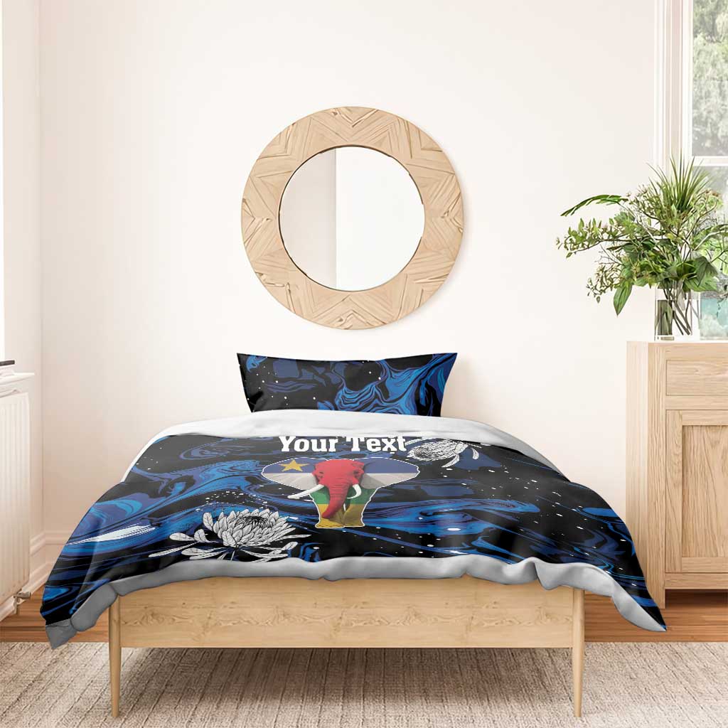 King bedding set on bed with blue-black elephant artwork, protea flowers, and custom text duvet