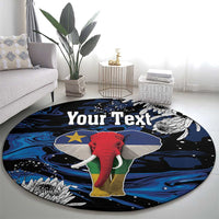 Round elephant printed rug with dark background, blue waves, gray wings, and white feathers
