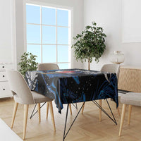 Black tablecloth with blue abstract pattern draped over dining table