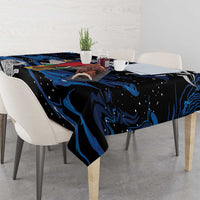 Black tablecloth with blue swirls and floral motifs draped on dining table