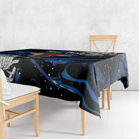 Black tablecloth with blue swirled design across tabletop edge