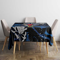 Black tablecloth with blue abstract print and flower details on dining table