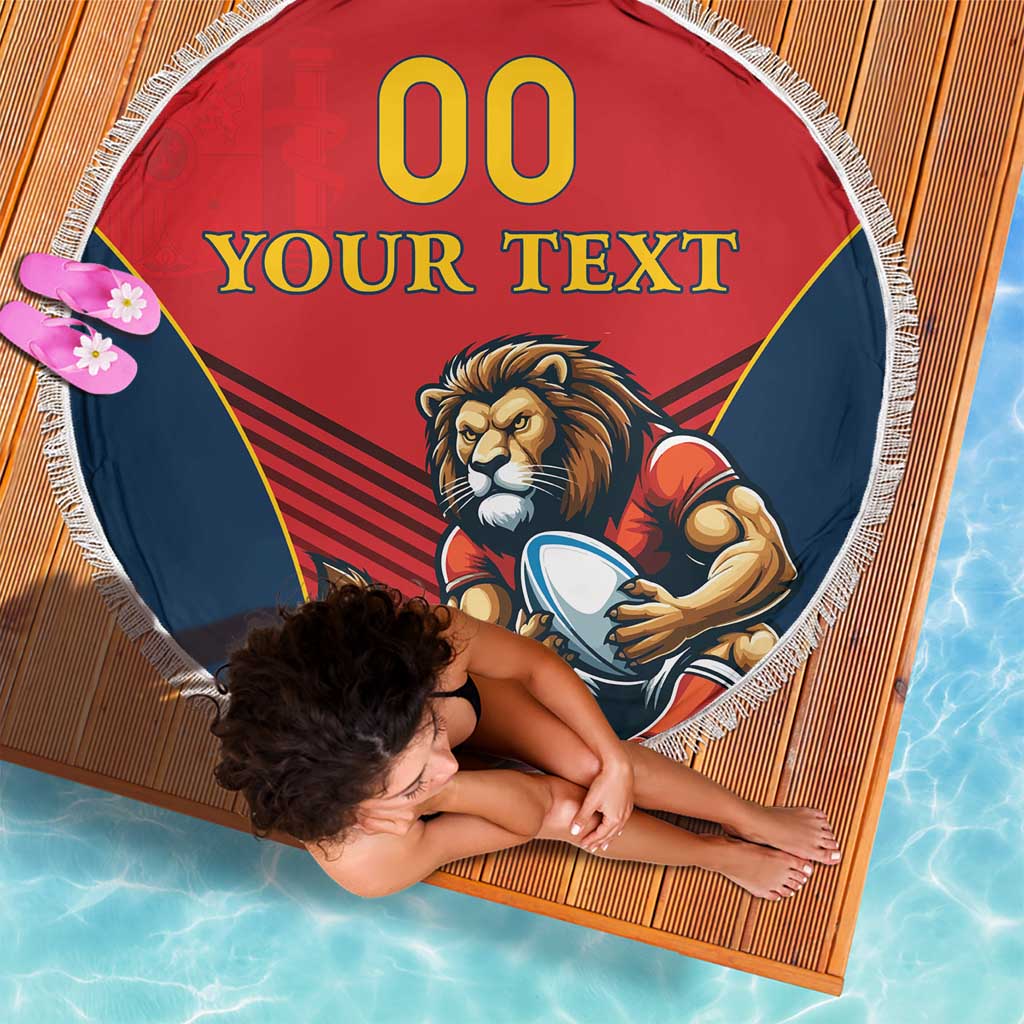 Round red beach blanket with blue panels, lion mascot illustration, and white fringe trim