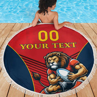 Round red beach blanket with lion mascot print and white fringe, blue side panels