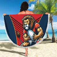 Round red beach blanket with lion mascot graphic, blue-and-yellow design, and white fringe edge