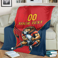 Spain rugby blanket on sofa with lion mascot, red center panel and navy sides