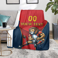 Spain rugby blanket on chair, lion mascot graphic in red and navy