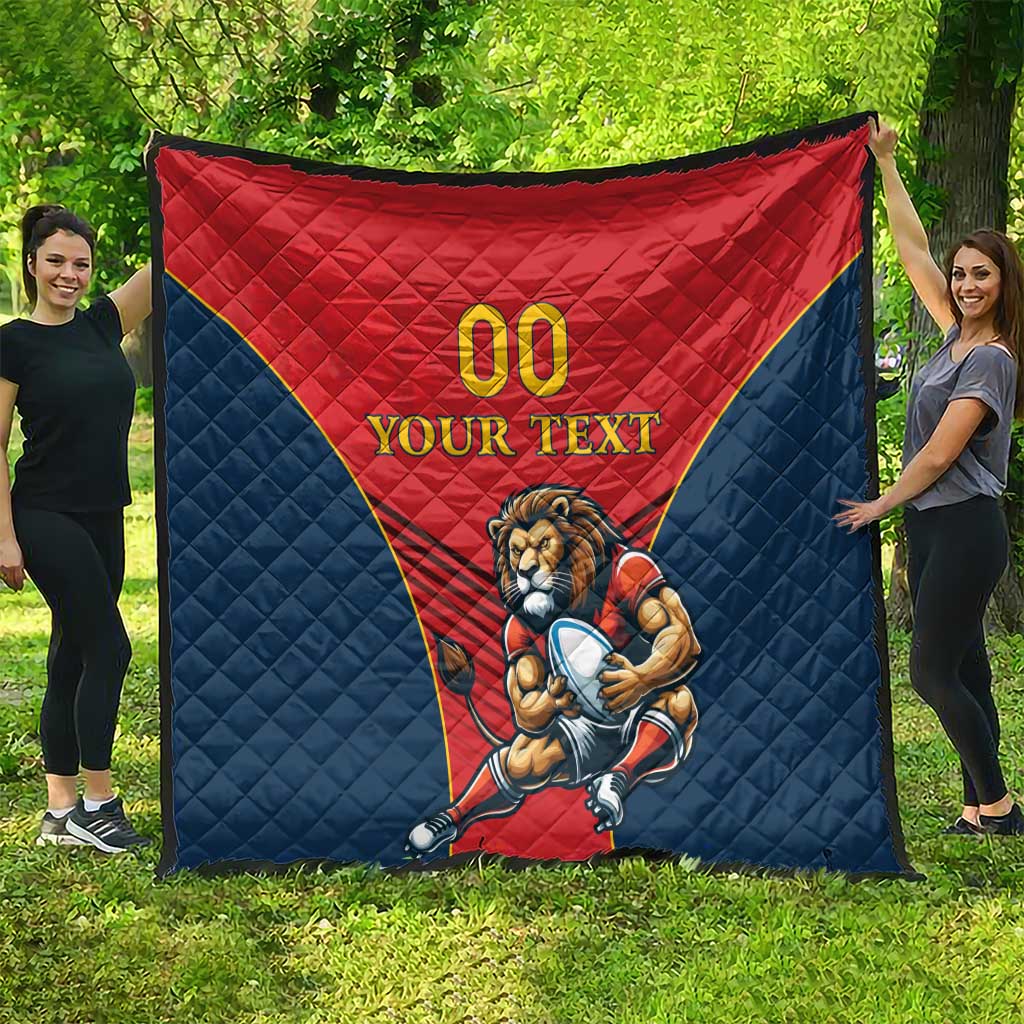 Rugby quilt blanket on grass, red center with lion mascot and “YOUR TEXT”