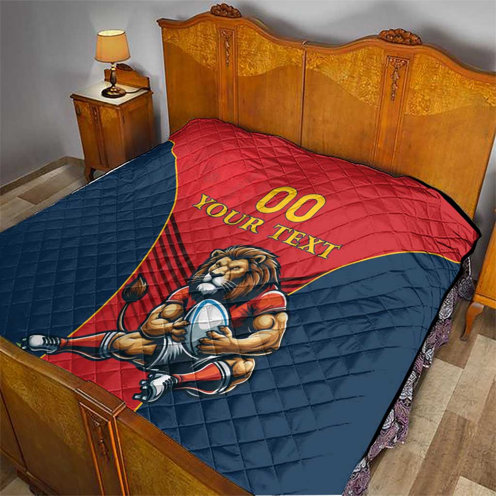 Rugby quilt blanket on bed, red and navy panels with lion mascot and “YOUR TEXT”