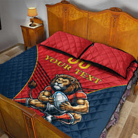 Red and navy quilt bed set with lion mascot and “YOUR TEXT” on quilt