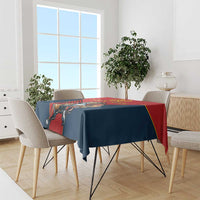 Red and navy lion rugby tablecloth draped over dining table with chairs